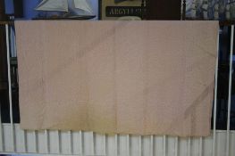 A very pale pink Durham quilt, with orange reverse