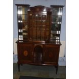 An Edwardian music cabinet, the top with central glazed door, flanked by open shelves, below a