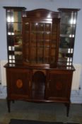 An Edwardian music cabinet, the top with central glazed door, flanked by open shelves, below a