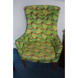 A pair of fern leaf upholstered wing armchairs