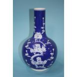 An Oriental blue and white vase, decorated with blossoms, marks in underglaze blue, 35cm height