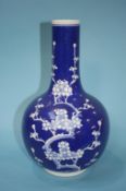 An Oriental blue and white vase, decorated with blossoms, marks in underglaze blue, 35cm height