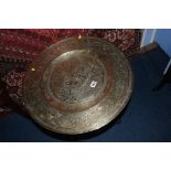 An Oriental folding engraved brass two tier table