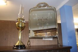 A brass oil lamp and a glass and brass fire screen