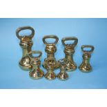 A set of seven graduating brass weights