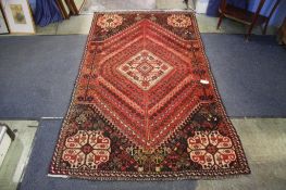 A Persian rug, with all over geometric design and central ivory pole medallion, ivory spandrels upon