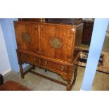 An oak four door cabinet, below two drawers, supported on turned supports, 118cm wide