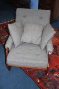 A teak framed armchair, with grey upholstery