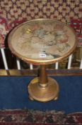 A circular petit point top occasional table