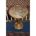 A circular petit point top occasional table