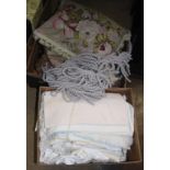 Two boxes of linen and fabrics