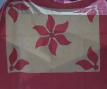 A white Durham quilt, the reverse with pink outer border, central floral medallion and pink floral