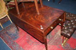 A 19th century mahogany drop flap table, with two drawers