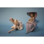 A Lladro figure of a girl holding flowers and a ballerina figure (2)