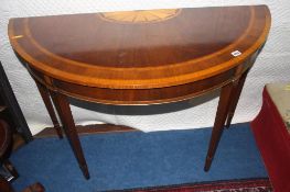 A reproduction mahogany Edwardian style half moon side table