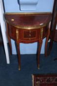 A Louis XV style half moon side table