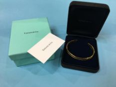 A Tiffany and Co. 18ct gold ‘Atlas Cuff’ bangle, stamped 750, dated 1995, weight 37.3 gram (boxed)