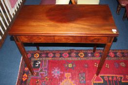 A 19th century mahogany fold over tea table