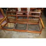 A Guy Rogers teak three seater settee (frame only)