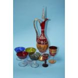A Continental red glass decanter, decorated with gilt decoration and enamels, having six matching