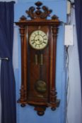 A double weight walnut cased Vienna wall clock
