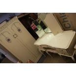 A cream wardrobe, dressing table etc.