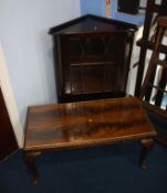 A coffee table and corner cabinet