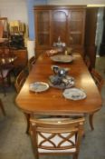 A yew wood display cabinet, table and six chairs