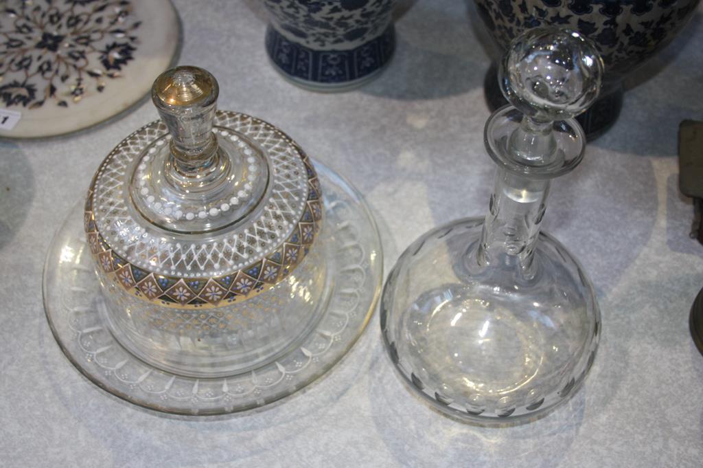 A clear glass and enamelled cheese dish and a decanter