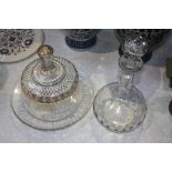 A clear glass and enamelled cheese dish and a decanter