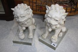 Pair of modern oriental lions on stands 26cm Height