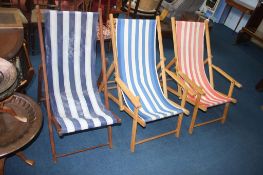 Three traditional folding deck chairs