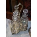 A silver plated three glass bottle stand