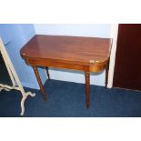 A 19th century mahogany fold over tea table