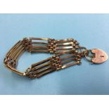 A 9ct gold gate link bracelet, with padlock fastener. Weight 16.9 grams