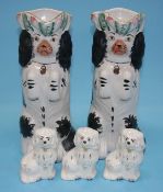 A pair of Staffordshire Spaniel water jugs and three mini Beswick Spaniels (5)