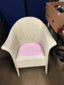 A cream Lloyd Loom chair