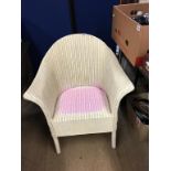 A cream Lloyd Loom chair