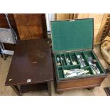 An oak card table and a canteen of cutlery