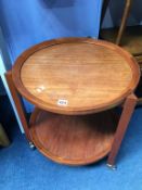 A teak circular two tier trolley, with triangular shaped supports, 52cm diameter