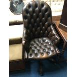 A brown Chesterfield high back office swivel chair