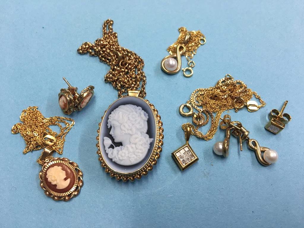 An 18ct gold and diamond pendant, two 9ct gold cameo pendants and a seed pearl pendant with