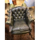 A green leather Chesterfield arm chair