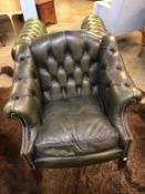 A green leather Chesterfield arm chair