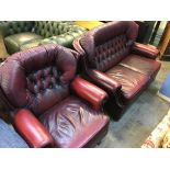 An oxblood Chesterfield two seater settee and an armchair