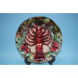 A large Palissy style plate, decorated with a lobster, 31cm diameter