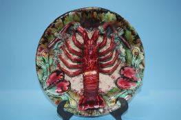 A large Palissy style plate, decorated with a lobster, 31cm diameter