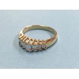 An 18ct gold diamond ring set with seven baguette cut diamonds (stamped 750)