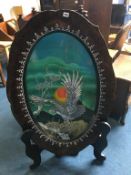 A large lacquered decorative plate on stand, 120cm long