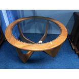 A teak circular coffee table, with inset glass top